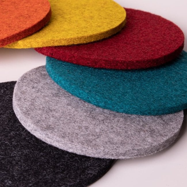 Set of round wool felt coasters in red, yellow, teal, grey, and black